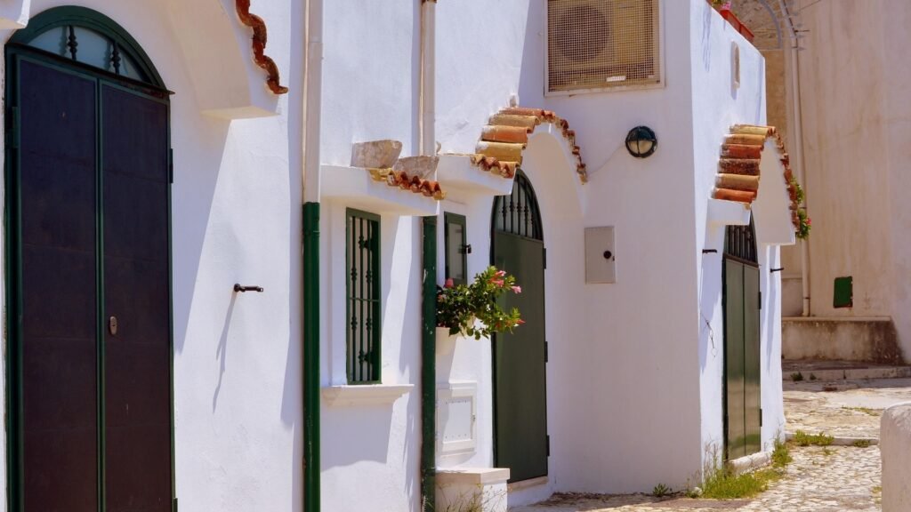 Bright white-washed Mediterranean architecture in South Italy, reflecting the clean, breathable, and organic philosophy of the puroBIO professional makeup range.